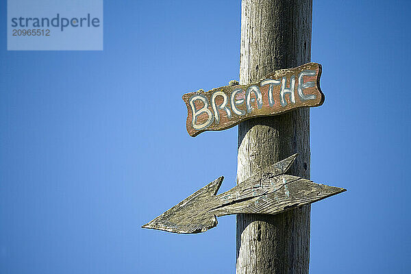 Breathe sign on telephone pole.