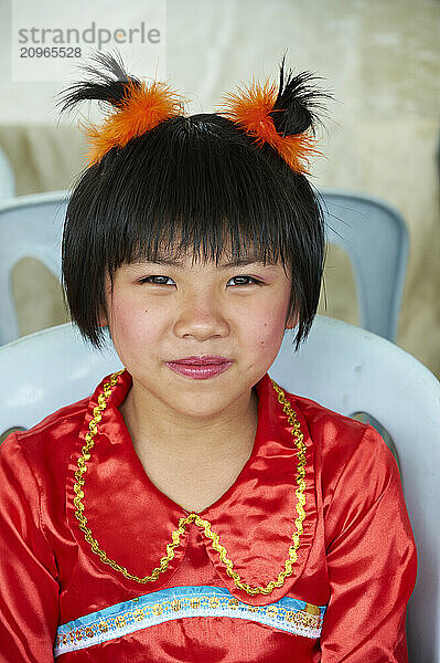 Young Malaysian girls dressed up in traditional costumes for a performance.