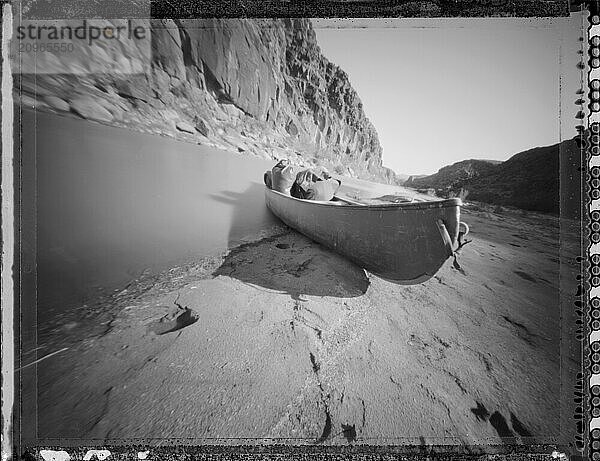 Canoe Beached by the River