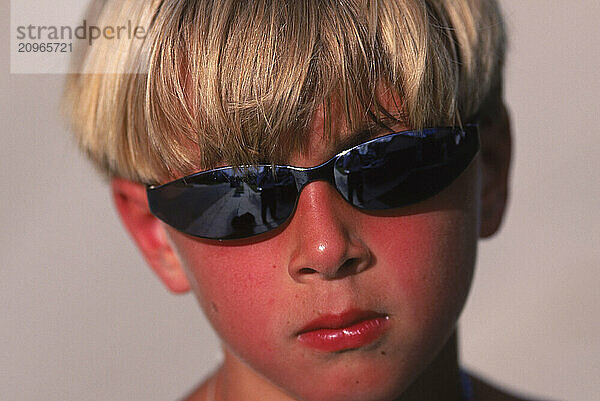 Close-up of boy wearing sunglasses.