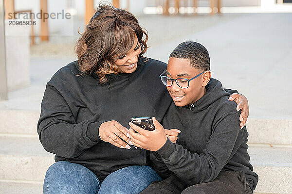 Aunt showing nephew her phone