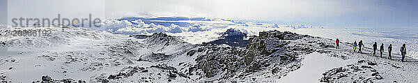 Climbers ascending the crater rim of Mt. Kilimanjaro  up from Stella Point  as seen from the summit area.