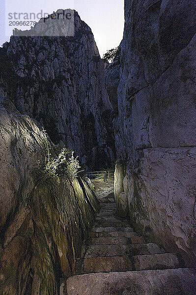 A spotlight on a blurred man walking to the San Huang Zhai Monastery on the Song Mountain  China.