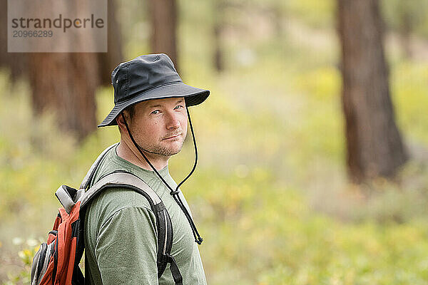 Male hiker looking at camera in the forest