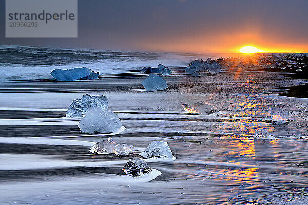 Ocean surf and icebergs on the black sand beach Breidamerkurjokull  Iceland