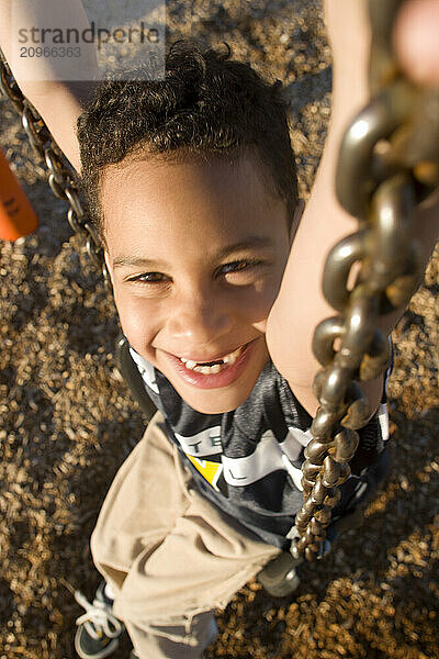 Young boy playing in playground in Sacramento  CA.