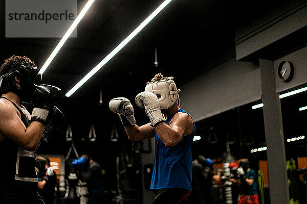 Boxers fighting in boxing training in the gym.