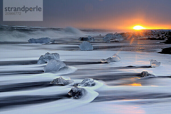 Ocean surf and icebergs on the black sand beach Breidamerkurjokull Iceland