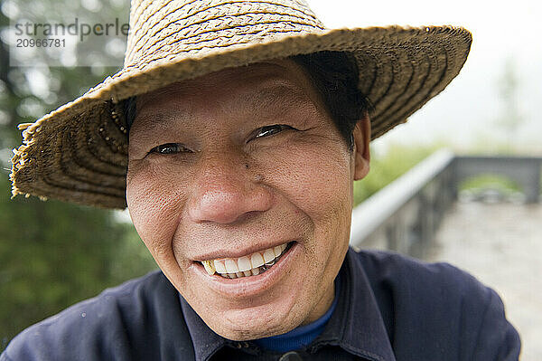 A smiling Chinese man at the San Huang Zhai Monastery on the Song Mountain  China.