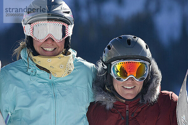 Portrait of a young female skier and young female snowboarder at Kirkwood  CA.