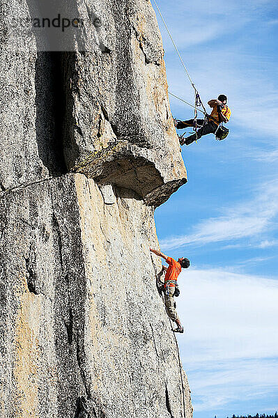 A photographer photographs a rock climber in Calif.