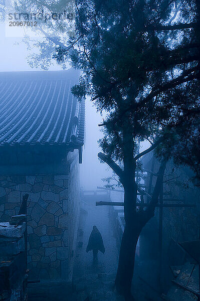 A man mysteriously wrapped in a blanket at the San Huang Zhai Monastery on Song Mountain  China.