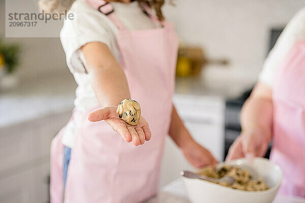 Close up of girls hand showing cookie dough