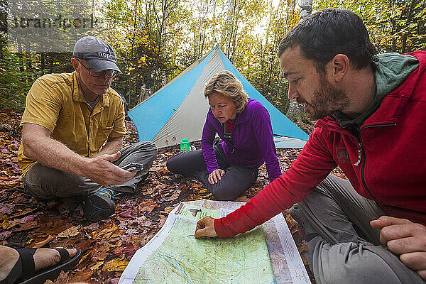 Hikers planning trip with map  Adirondack Mountains  New York State  USA