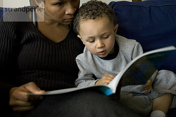 A mother reads to her son.