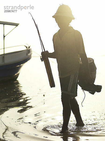 An elderly fisherman at sunset in Bali  Indonesia.