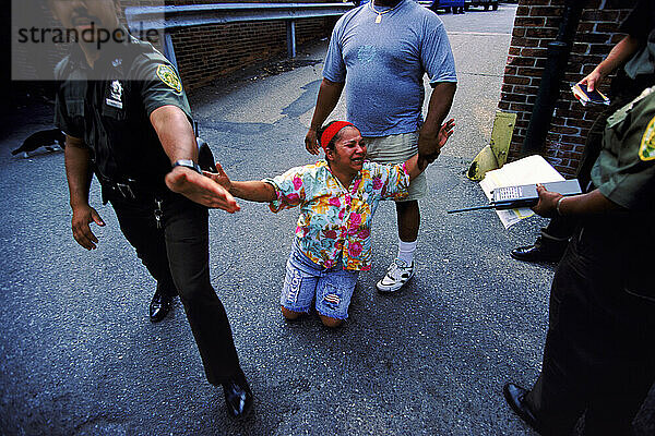 Police taking a woman's daughter.