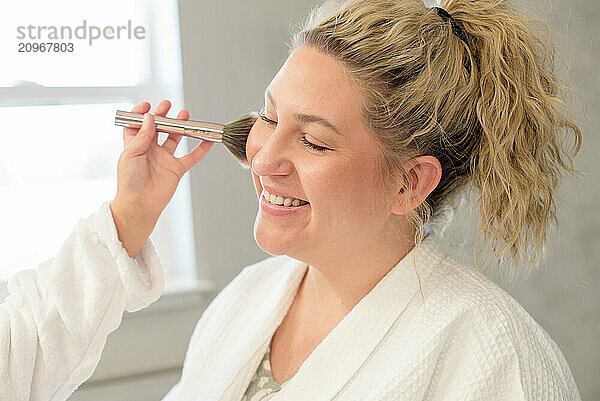 Close up of mother getting her make up done by little daughter