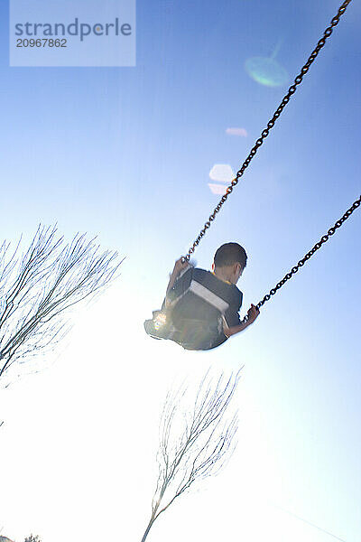 Young boy playing in playground in Sacramento  CA.