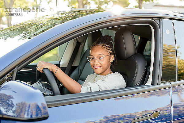 Young adult driver in the drivers seat of a car