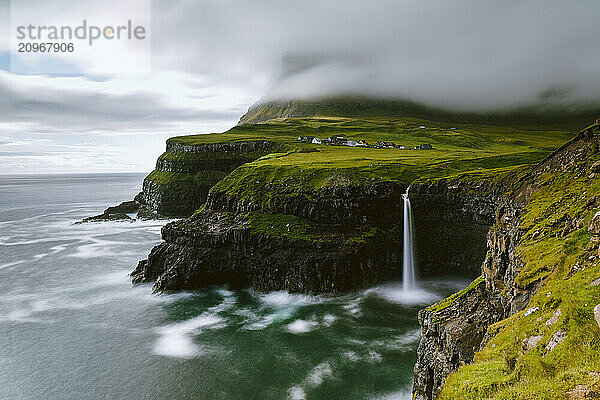 Waterfall on cliff on seashore  Gasadalur  Vagar  Faroe Islands