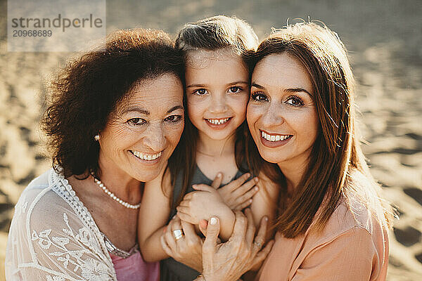 Portrait three generations beautiful Spanish women at beach