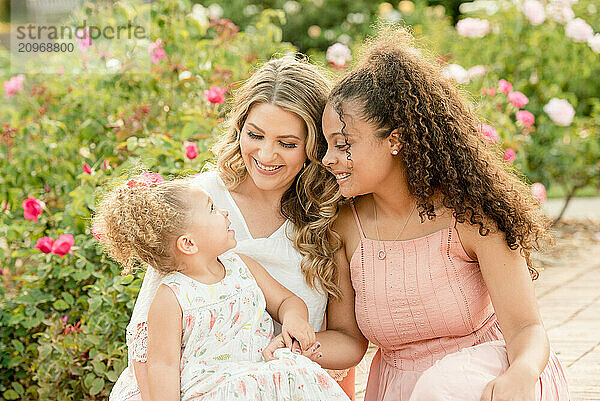 Mother with biracial daughters in garden