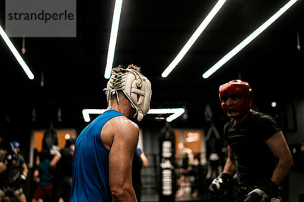 Boxers fighting in boxing training in the gym.