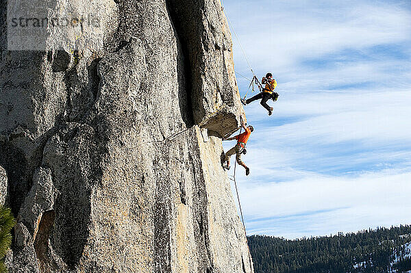 A photographer photographs a rock climber in Calif.