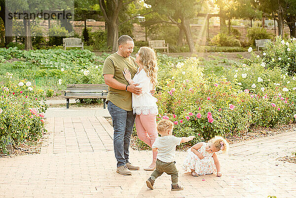 Kids playing around parents in garden