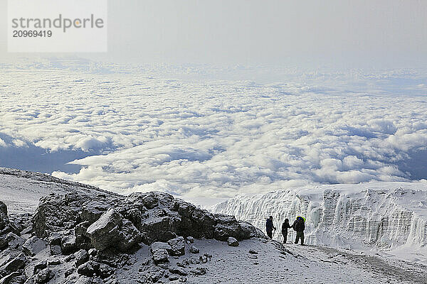 Climbers ascending the crater rim of Mt. Kilimanjaro  up from Stella Point  as seen from the summit area.