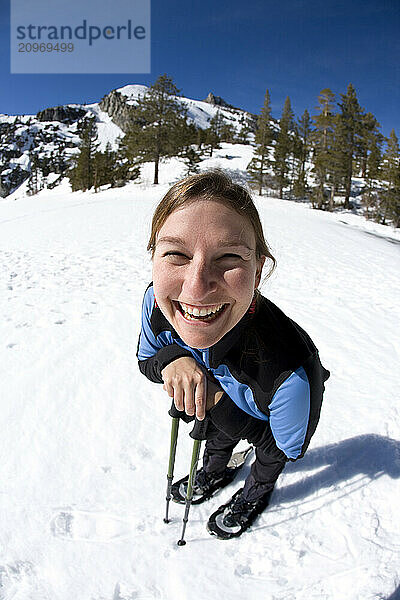 Young woman snowshoeing near Lake Tahoe  California.