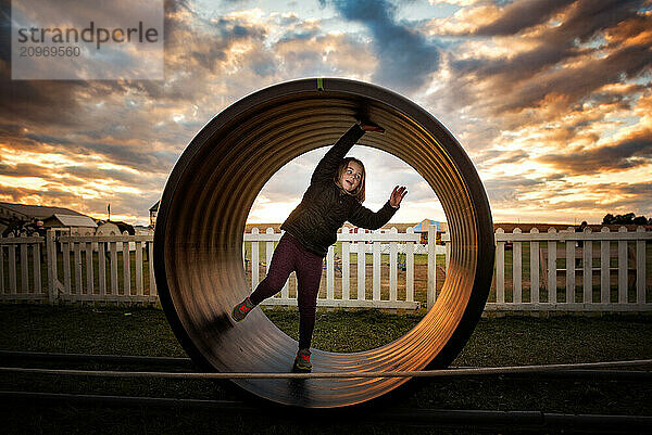 Young girl playing at park at sunset