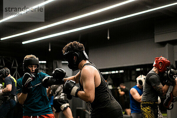 Boxers fighting in boxing training in the gym.