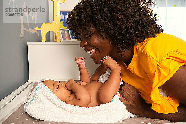 Mother is bonding with her baby after bath time