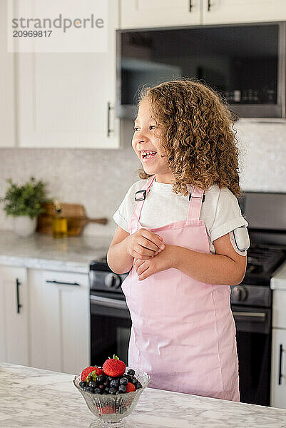 Little girl with diabetes laughing in the kitchen