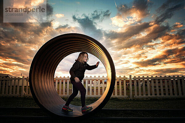 Happy young girl playing at park sunset