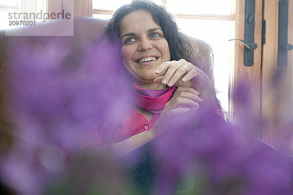 Woman smiling with flowers in foreground  Lovell  Maine.