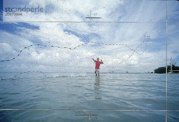 Casting a net for bait fish in Biscayne Bay.