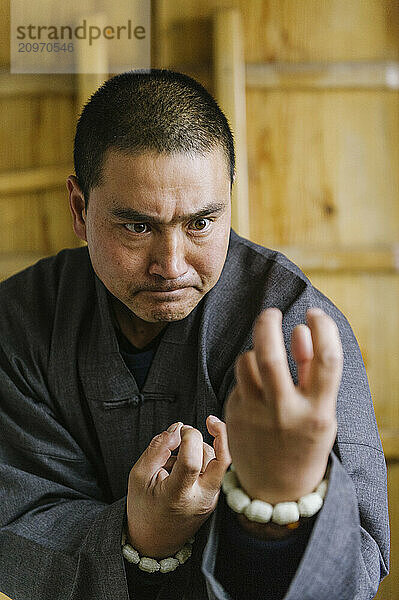 Shaolin Monk Shi De Jian demonstrates traditional martial arts at the San Huang Zhai Monastery on the Song Mountain  China.