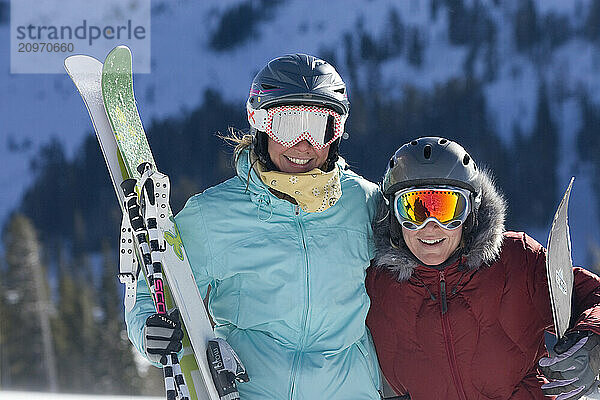 Portrait of a young female skier and young female snowboarder at Kirkwood  CA.