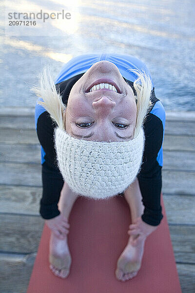 Young woman doing yoga on pier in Tahoe City  CA.