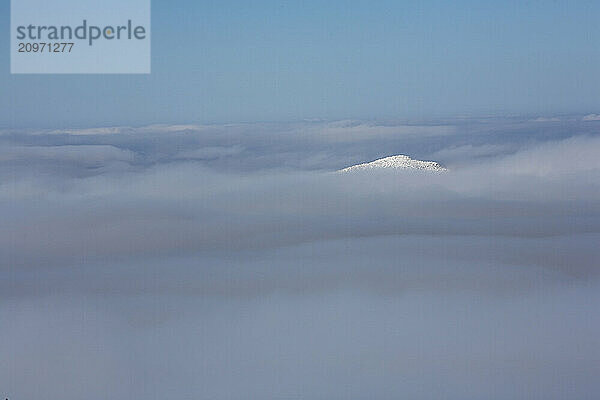 The very peak of Mt. Madison in the Presidential Range of New Hampshire surrounded by thick clouds.