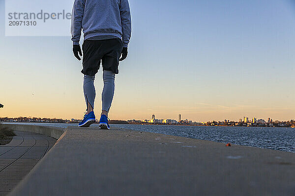 Man in sportswear standing on coastline