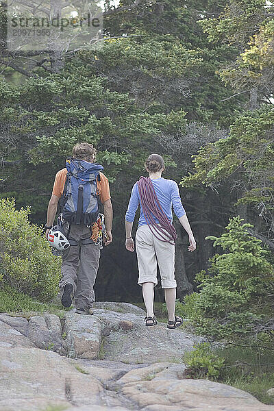 Two rock climbers finish a day rock climbing  Maine.