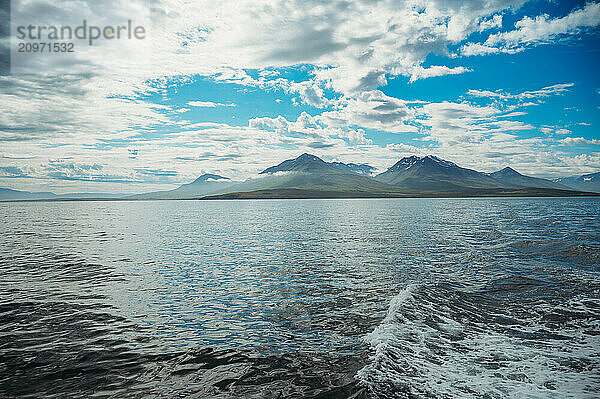 Ocean view from a boat in Dalvik  Iceland with blue sky and mountains