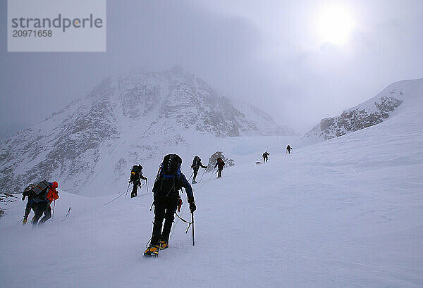 Mountaineers in windy weather between camp 3 and 4 on the West Buttress route of Denali  Alaska