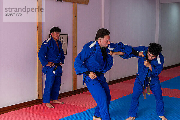 Judo fighters fighting in dojo