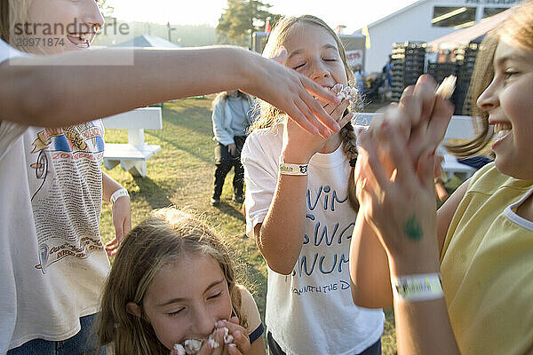 Girls enjoying maple sugar cotton candy at the Fryeburg Fair in Maine.