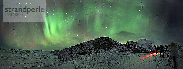 Photography group witnesses the aurora borealis over Hoffellsjkull  eastern Iceland.